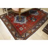 An Indian red ground rug 210 x 150cm