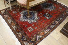 An Indian red ground rug 210 x 150cm