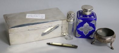 An Edwardian silver cigarette box, two mounted scent bottles, a silver salt and a silver fruit