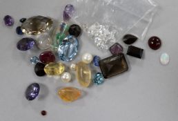 A quantity of unmounted gem stones including cabochon ruby etc.