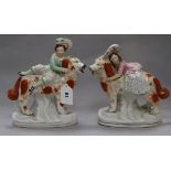 A pair of Staffordshire groups of a Prince and Princess riding dogs H 32cms