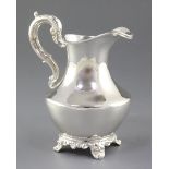 An early Victorian silver cream jug, by William Hunter, hallmarked London, 1856, of plain, shaped