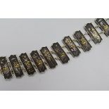 A Japanese mixed metal bracelet with twelve decorated rectangular plaques, 18.5cm.