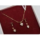 A pair of diamond and 9ct gold heart-shaped earrings and a similar pendant on 18ct gold chain.