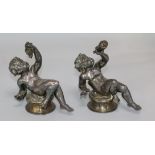 A pair of silvered bronze cherubs
