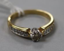 A solitaire diamond ring with diamond set shoulders, 18ct gold shank, size Q.