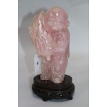 A large rose quartz figure of a boy
