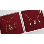 A blue topaz and 9ct gold necklace and earrings en suite and a 9ct gold and garnet openwork