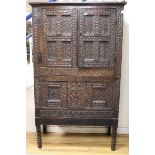 An 18th century carved oak cupboard W.112cm