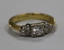 An 18ct gold and single stone diamond ring with diamond set shoulders, size H.