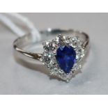 A sapphire and diamond cluster ring, 18ct white gold shank, size V.