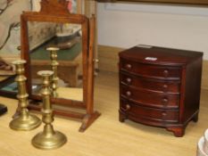 A mahogany toilet mirror, a pair of Victorian brass candlesticks and a miniature bowfronted chest of