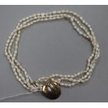 A triple strand freshwater pearl necklace with yellow metal clasp, 41.5cm.