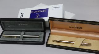 A Waterman blue-lacquered pen and pencil set, a Waterman pencil, a Sheaffer gold plated pencil and