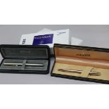 A Waterman blue-lacquered pen and pencil set, a Waterman pencil, a Sheaffer gold plated pencil and