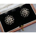 A pair of 9ct gold and diamond set starburst earrings, diameter 17mm.