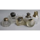 A miniature decanter and cup, a match strike, three inkwells and a perfume bottle.