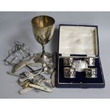 A cased set of four silver napkin rings, two cast silver wine labels with hunting scenes, a silver