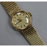 A lady's 9ct Omega manual wind wrist watch on integral Omega 9ct gold bracelet.