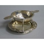 A late 19th/early 20th century Chinese Export silver tea strainer and stand by Wang Hing, Hong Kong,