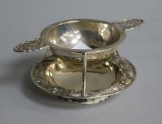 A late 19th/early 20th century Chinese Export silver tea strainer and stand by Wang Hing, Hong Kong,