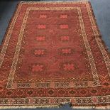 A red ground rug 218cm x 151cm