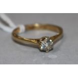 A yellow metal and solitaire diamond ring, size O.