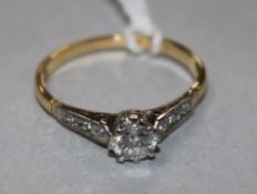 An 18ct gold and platinum diamond solitaire ring, size O.
