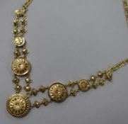 A yellow metal (tests as 14ct) disc necklace, comprising five graduated floral-engraved discs on 9ct