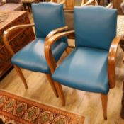 A pair of leather French chairs