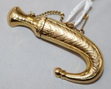 A yellow metal (tests as 14ct) dagger and sheath brooch, with safety chain, 5cm.