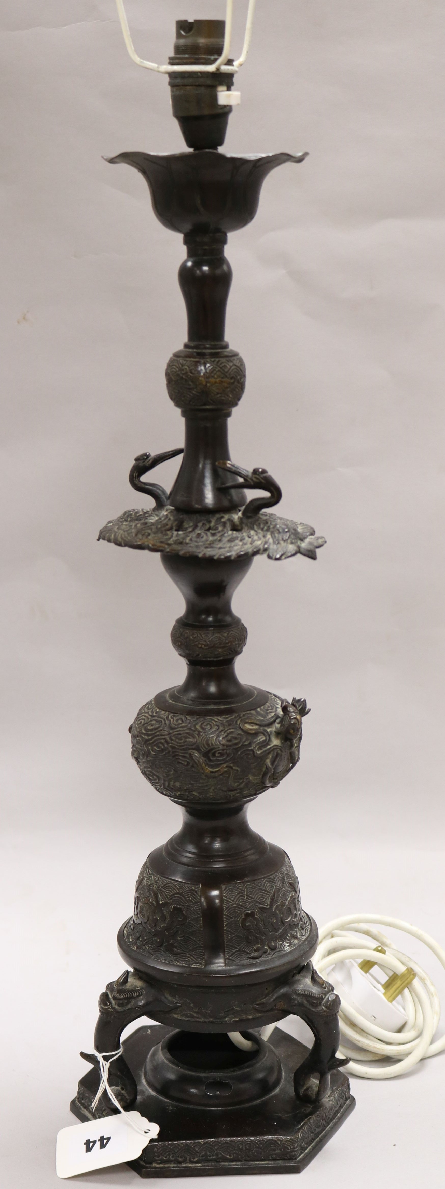 An Oriental bronze lamp base H 51cms