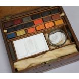 A Newman's artists painting box, with palet and paints H 8.5cm x W 23.5cms