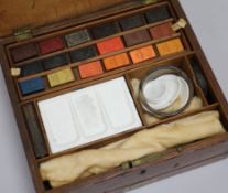 A Newman's artists painting box, with palet and paints H 8.5cm x W 23.5cms