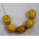 A 9ct gold chain set with five simulated amber beads