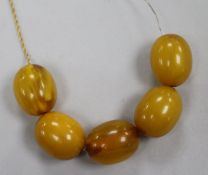 A 9ct gold chain set with five simulated amber beads