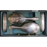 A cased Edwardian silver six piece dressing table set.