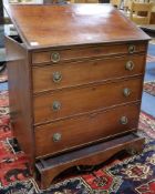 A George III mahogany draughtmans chest of four drawers with rising top and unusual base compartment