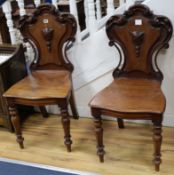 A pair of Victorian hall chairs