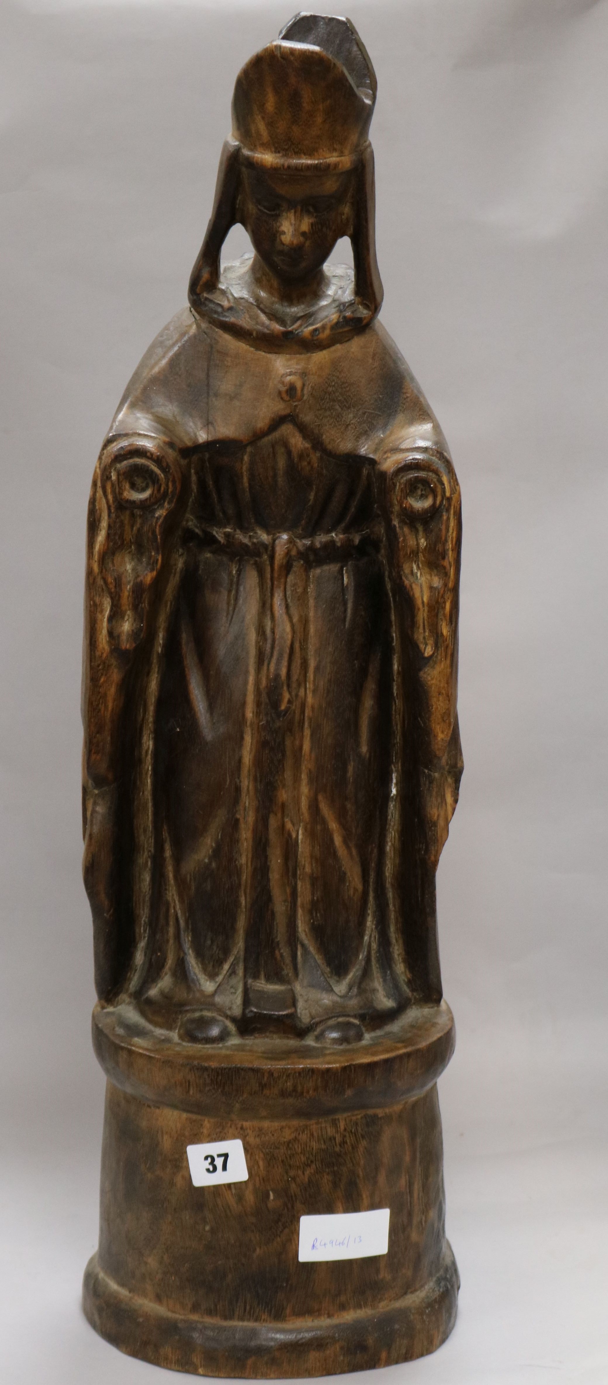 A carved wood figure of a Bishop H 69cms