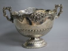 A demi fluted white metal two handled oval pedestal bowl, 26cm over handles.