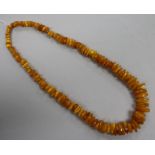 A single strand jagged amber bead necklace, gross weight 74 grams, 64cm.