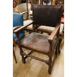 An oak and leather elbow chair