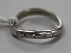 A modern platinum and five stone diamond ring, size M.