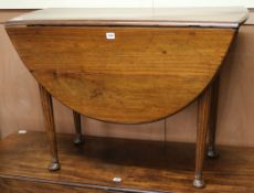 A George III mahogany oval topped drop leaf dining table W.97cm