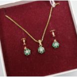 An emerald and diamond cluster pendant and a pair of earrings en suite, 9ct gold settings and