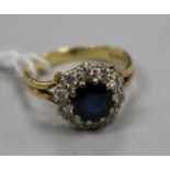 A modern 18ct gold, sapphire and diamond set cluster ring, size K.