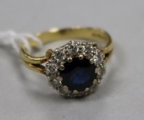 A modern 18ct gold, sapphire and diamond set cluster ring, size K.