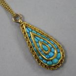 A late 19th/early 20th century Indian? yellow metal and turquoise set teardrop shaped pendant, on