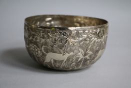An Indian white metal circular bowl, chased with animals, 11.5cm.